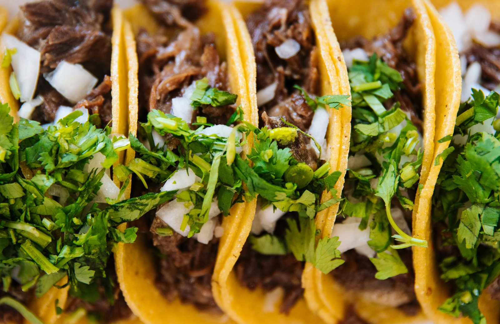 Friends celebrating with authentic Mexican food catering — tacos, burritos, nachos and aguas frescas from Los Periquitos Santa Cruz
